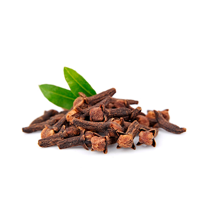 A pile of dried clove buds with their distinctive brown, woody texture and bulbous tops, accompanied by two fresh green leaves, displayed on a white background.